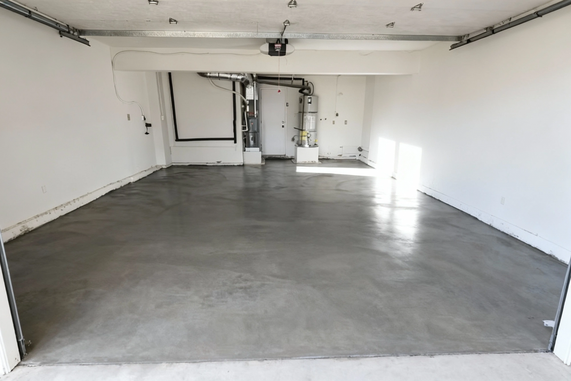 Workers smoothing wet concrete slab to create a stable foundation surface